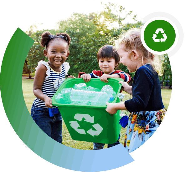 Three children holding a green bin with the recycling symbol on it.